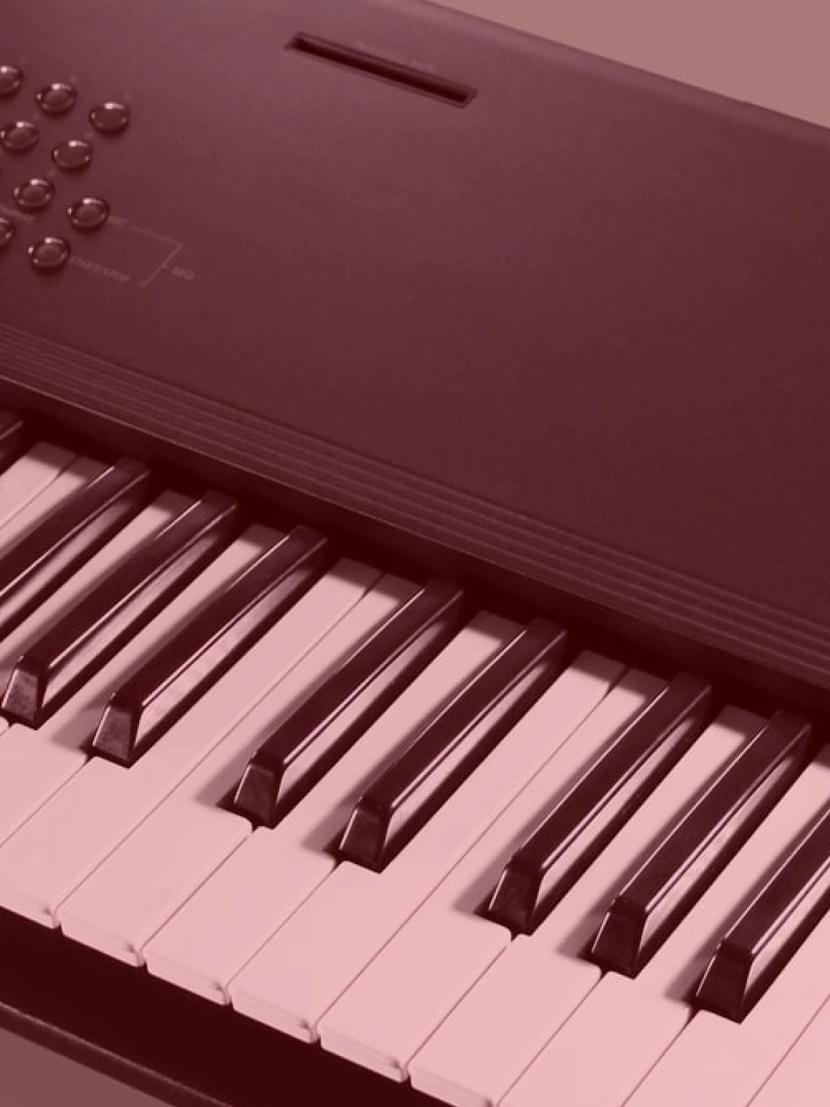 Close-up of a red digital piano keyboard The Korg M1