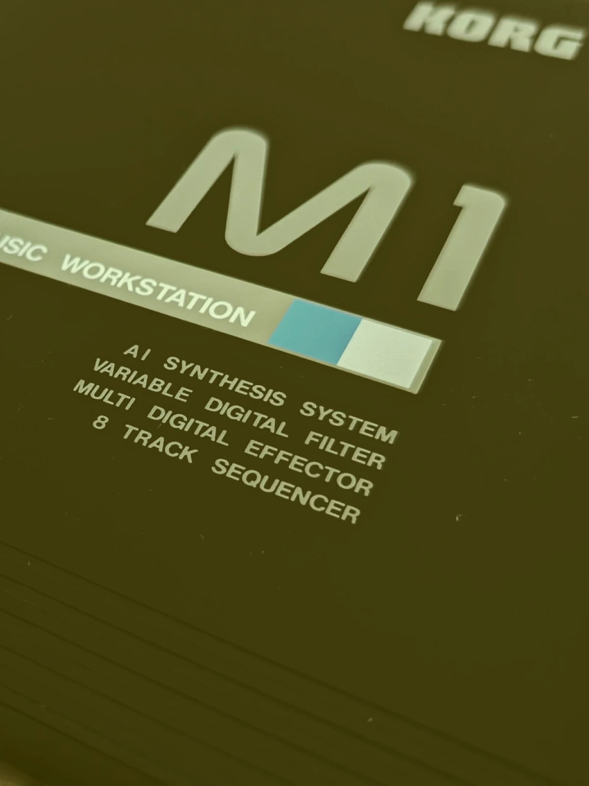 Korg M1 music workstation with text on a dark background