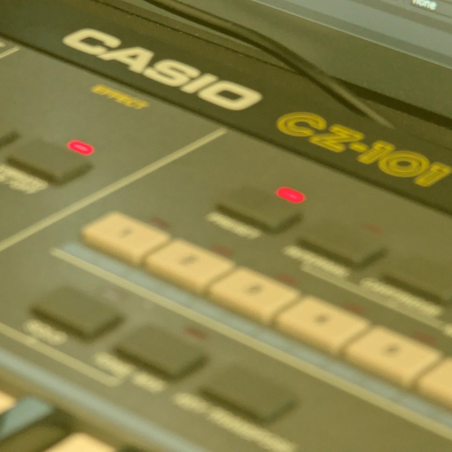 Close-up of a Casio CZ-101 synthesizer with visible buttons and branding.