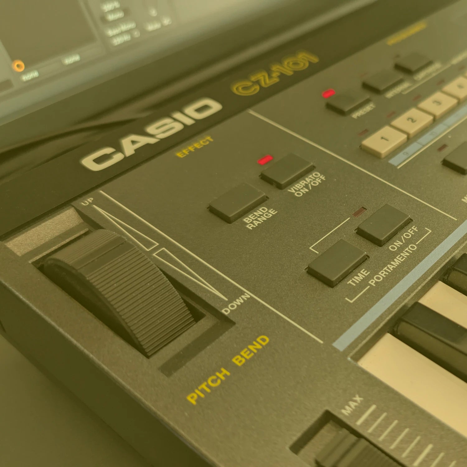 Close-up of a Casio  CZ-101 synthesizer with control knobs and buttons.